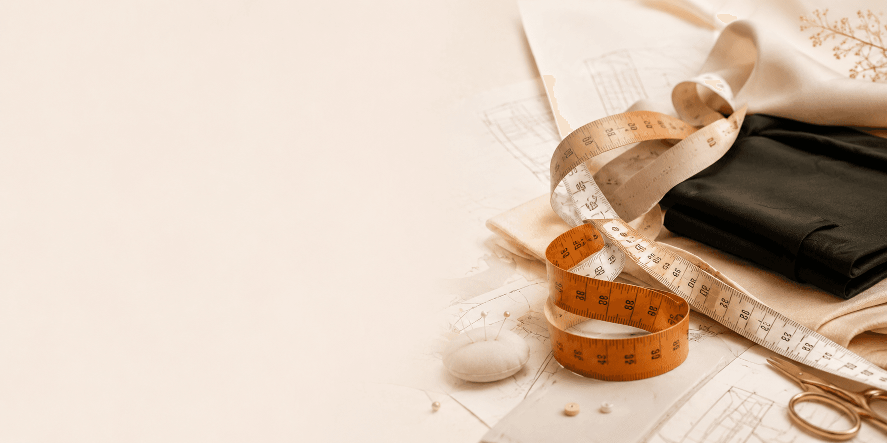 Measuring tape and tailoring materials beside folded fabric